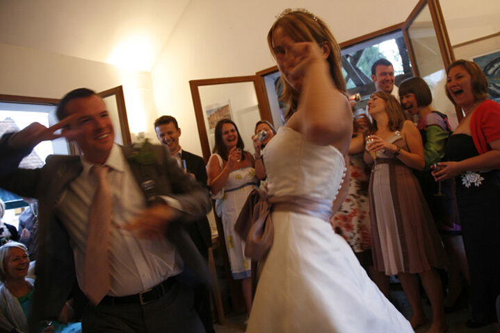 A bride dancing among her guests at an evening party