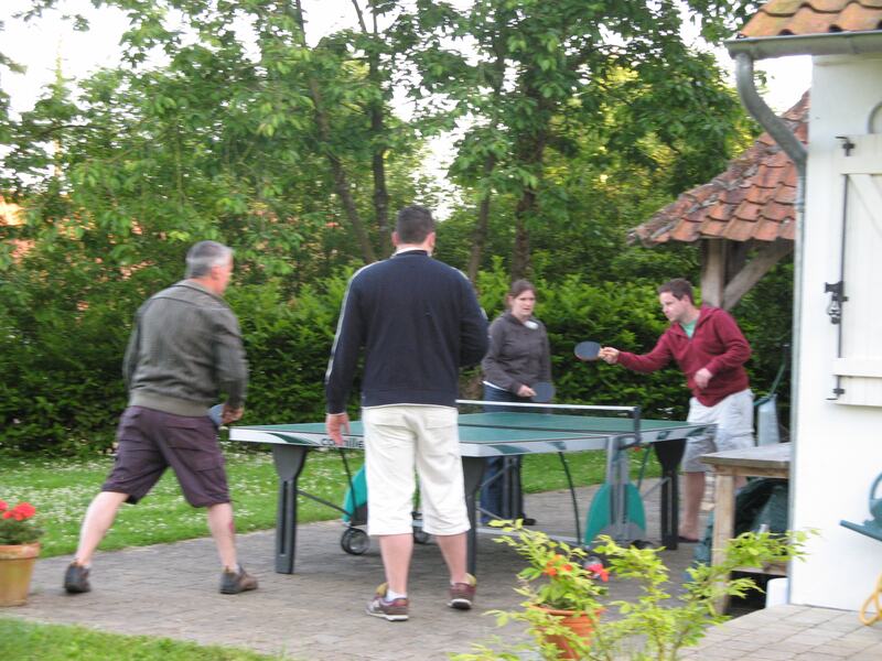 Guests playing table tennis on the patio beside the house, June 2009