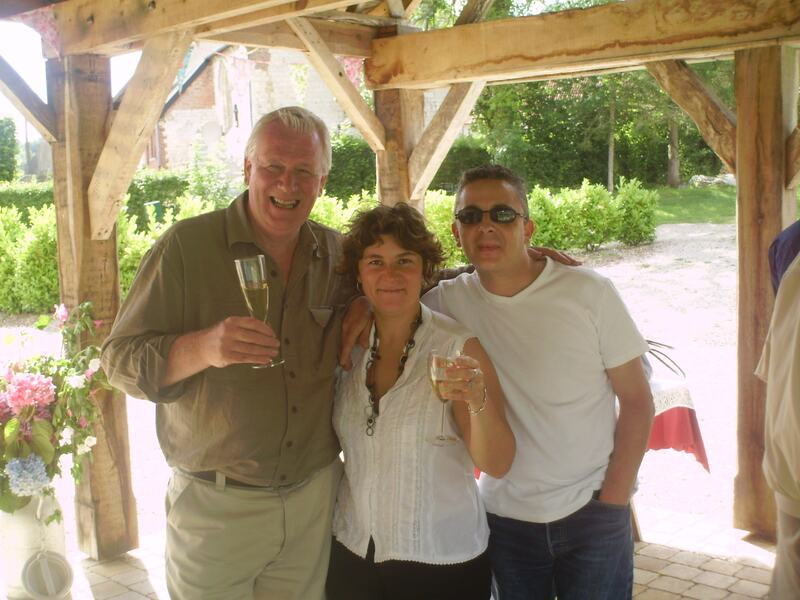 Three people raising glasses of champagne under the timber covered terrace