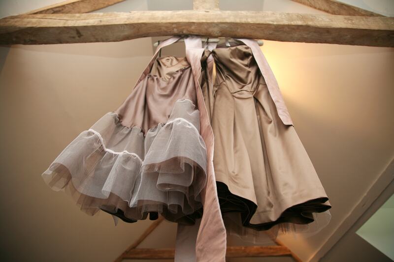 Dresses hanging from the beams on a wedding morning