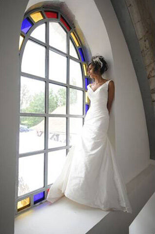 A bride in the window of the old chapel